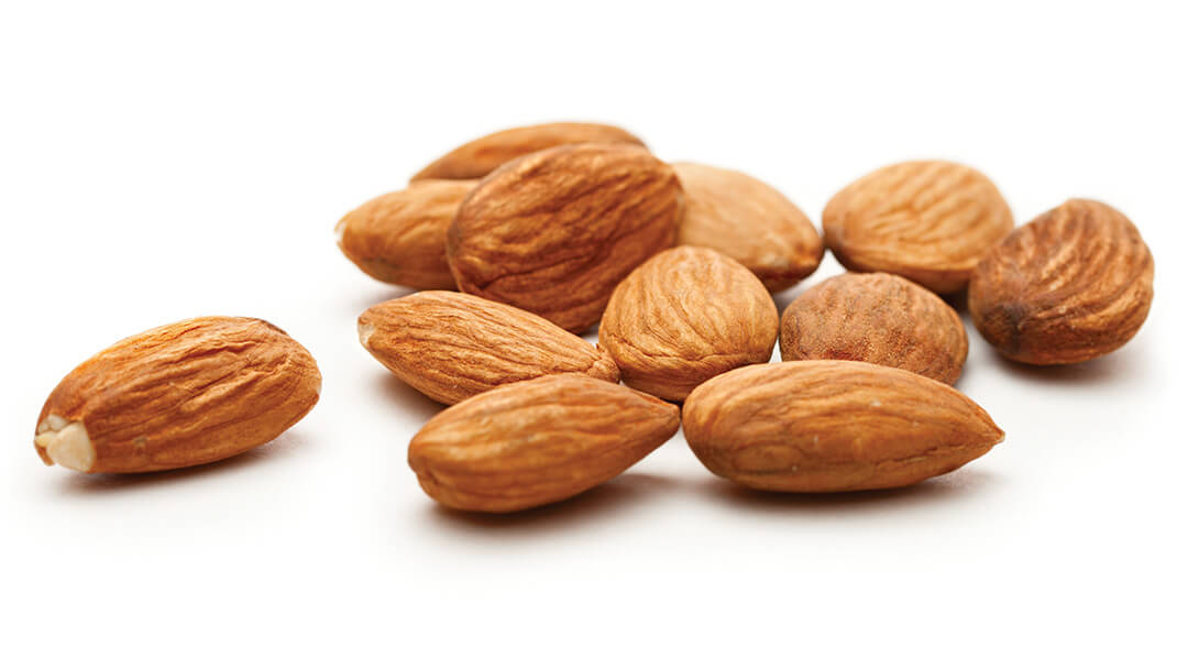 Several almonds lay on a flat surface