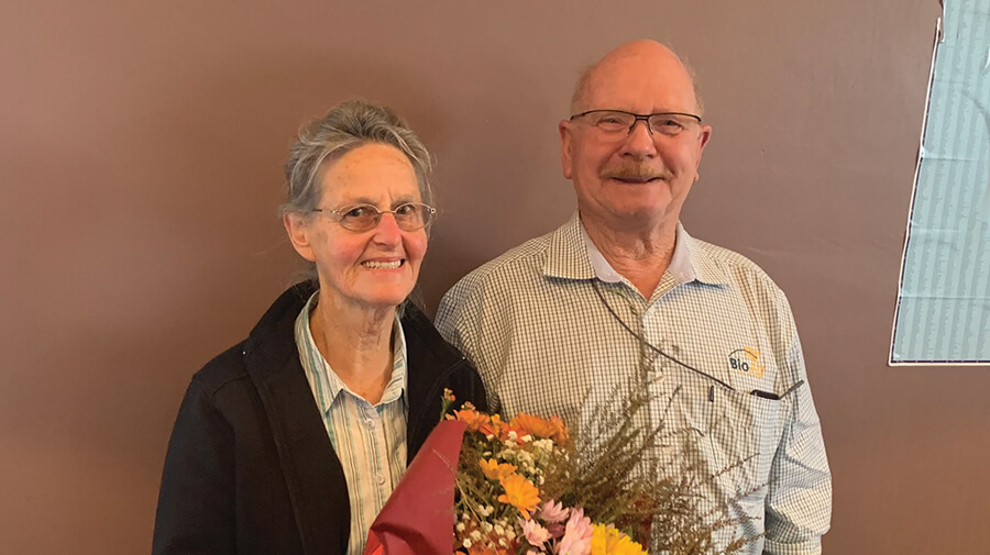 Ivan and Coral Mitchell holding flowers for Ivan's farewell